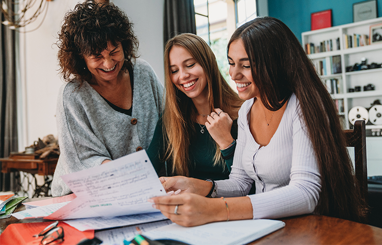 Mother and daughters looking at forms